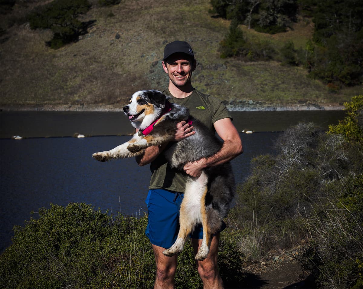 Greg holding Jessa beside a reservoir